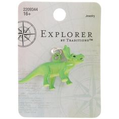 a small green dinosaur charm on a card