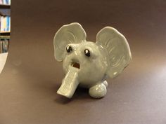 an elephant figurine with its trunk sticking out