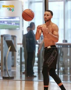 a shirtless man playing basketball in an airport