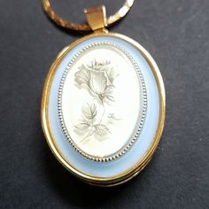 Please See Pictures For Details. New Condition, Long Gold Tone Chain Like A Box Chain. Locket Is Gold Tone, Plain In The Back Front Is Slate Blue Border With Frosted Glass And Charcoal Flower. This Is Old, Close To Vintage Never Worn. Light Blue Metal Jewelry For Gifts, Vintage Blue Necklace For Anniversary, Vintage Blue Jewelry With Chain, Vintage Blue Chain Jewelry, Light Blue Metal Necklace For Gift, Elegant Metal Jewelry Keepsake, Vintage Blue Keepsake Jewelry, Chain Locket, Large Locket