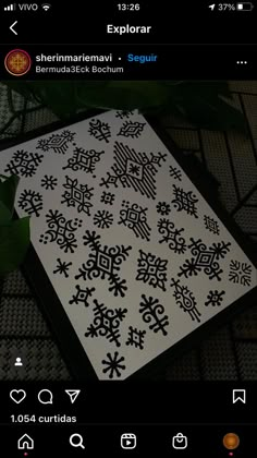 an image of a black and white snowflake pattern on a cell phone screen