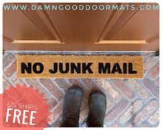 a door mat with the words no junk mail on it next to a pair of boots