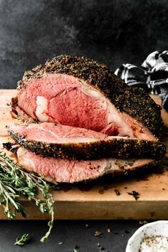 a large piece of meat sitting on top of a wooden cutting board