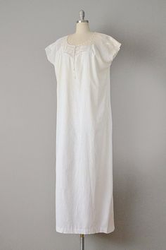 "This Victorian night gown is made from soft, off-white cotton in a beautiful, simple design. The top has a yoke of crocheted cotton lace, with a rounded, drawstring collar. Dolman-like sleeves transition into the straight cut skirt of the piece. Would look great belted, or on its own as a summer day look. Pullover fit. Size: M, L, XL. Bust: 52\" Waist: 56\" Hips: 56\" Length: 58\" Label: None. Condition: Excellent vintage condition (tiny pin-hole near front hem). All vintage is sold in \"as-is\ Cotton Summer Nightgown For Weddings, Cotton Nightgown For Summer Weddings, Summer Cotton Nightgown For Wedding, Summer Cotton Wedding Nightgown, Cotton Lace Trim Sleepwear For Wedding Night, Elegant Fitted Cotton Nightgown, Fitted Cotton Nightgown For Home, Cotton Nightgown With Lace Trim For Wedding Night, Cotton Delicate Lace Dress For Daywear