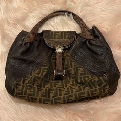 This Fendi Tortoise Spy Bag Zucca Canvas And Leather, Crafted From Brown Zucca Canvas And Leather, Features Dual Rolled Genuine Tortoise Skin Handles, Pleated Silhouette, "Secret" Compartment At Its Flap Closure And Gold And Silver Tone Hardware. Its Flap Closure Opens To A Neutral Fabric Interior. Estimated Retail Price: $2,050 Condition: Great. Wear On Opening Corners And Exterior Leather Trims, Pilling In Interior, Scratches On Hardware. Measurements: Handle Drop 6", Height 11", Width 15", De Fendi Spy Bag, Spy Bag, Brown Logo, Brand Name Clothing, Browning Logo, Bags Logo, Givency Antigona Bag, Fendi Bags, Michael Kors Monogram