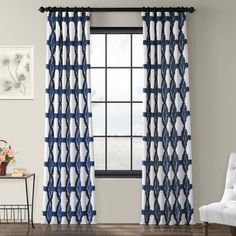 blue and white curtains hanging in front of a window