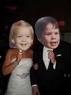 a young man and woman posing for a photo with a cardboard cut out of them