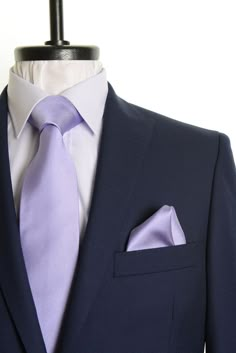 a suit with a purple tie and pocket square