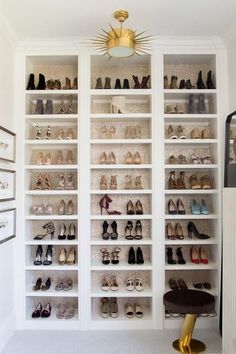 a white closet filled with lots of shoes