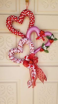 two heart shaped wreaths hanging on the front door