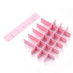 a group of pink shelves sitting on top of a white table next to each other