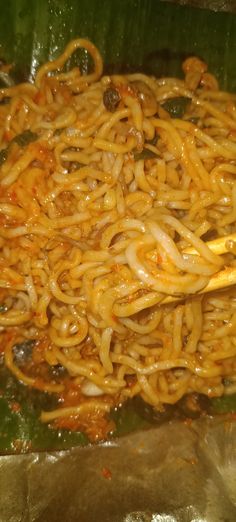 some noodles are being cooked in a pan