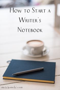 a notebook and pen sitting on top of a table next to a cup of coffee