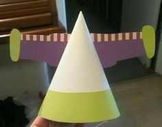 a hand holding a paper party hat