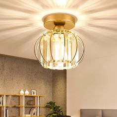 a living room with a couch, coffee table and lamp on the ceiling above it