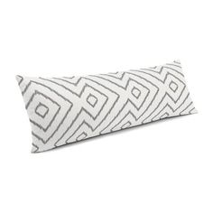 a white and grey pillow on a white background with a black diamond pattern in the middle