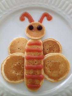 a plate with pancakes shaped like a caterpillar