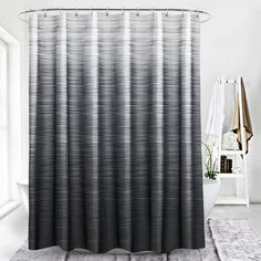 the shower curtain is black and white in color