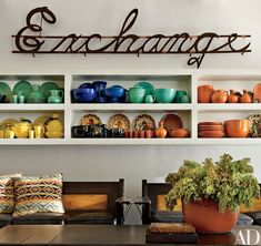 a table with plates and bowls on it in front of a sign that says exchange