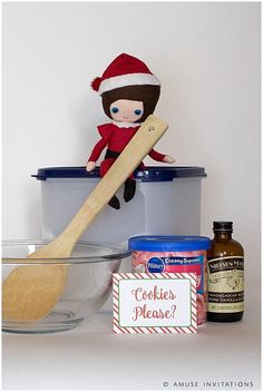 an elf doll sitting on top of a bowl with ingredients