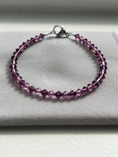 Beautiful Amethyst Swarovski/Preciosa Cyrstal Bracelet! This handmade bracelet features genuine crystals with a stainless steel lobster clasp. This bracelet is perfect for anyone who loves purple! It has a brilliant sparkle; especially in the sun or any kind of light. This specific bracelet measures at approximately 7" (see last photo) and is ready to ship. If you need a different size, just message me and I can custom make one for you! All of my bracelets are handmade with love by me! Thank you for looking and supporting my small business! Elegant Nickel Free Purple Bracelets, Elegant Nickel-free Purple Bracelets, Purple Crystal Beaded Bracelets As Gift, Purple Crystal Bracelets With Round Beads, Purple Crystal Bracelets As Gift, Purple Crystal Bracelet As A Gift, Purple Crystal Bracelets For Gift, Faceted Crystal Bracelet For Jewelry Making, Sterling Silver Faceted Crystal Bracelet Gift