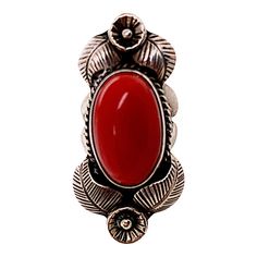 This is part of Chairish’s Costume Jewelry assortment.  A fine vintage silver Native American ring featuring a large deep colored red bezel set cabochon coral. Each side is decorated with an engraved flower and leaves. There is a rope twist border around the coral's beze. There are no marks and it tests silver. Condition is excellent.  Dimensions:  Size 6 3/4, Top length: 1 3/4", Largest width: 7/8", Weight: 14.1 grams Bezel Set Cabochon, Flower And Leaves, Green Cocktail, Engraved Flower, Native American Rings, Rope Twist, Coral Ring, Gold Cocktail Ring, Gold Cocktail