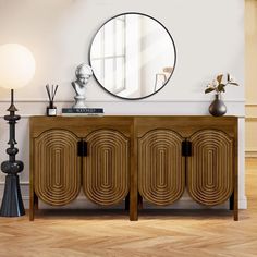 an art deco sideboard with round mirror on the wall