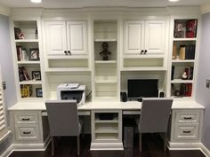 a home office with built - in shelving and desk