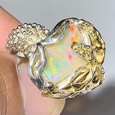 Ethiopian Handmade Sterling 925 Opal Ring Ring Size: 9 Weight Ring: 45.05ct Opal Size: 14.1mm X 8.0mm X 4.6mm Descubra la belleza única de las piedras de ópalo Etíope. Sumérgete en un mundo de color y brillo inigualable con estas gemas de origen Etíope. Cada piedra es una obra maestra de la naturaleza, con patrones y tonos que te dejarán sin aliento. ¡Atrévete a lucir la elegancia y originalidad de las piedras de ópalo etíope en tus joyas! ¡No se conforme con lo ordinario, luzca con estas piedra Luxury Silver Opal Promise Ring, Luxury Silver Opal Jewelry, Luxury Silver Opal Ring, Luxury White Gold Opal Ring As Gift, Luxury White Gold Opal Ring Gift, Silver Opal Jewelry With Prong Setting, Luxury Silver Opal Ring, Hallmarked, Luxury Silver Opal Ring Hallmarked, Luxury Untreated Jewelry For Gift