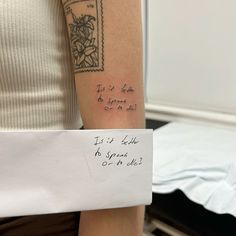 a woman with a tattoo on her arm holding a piece of paper that says it is love to grow