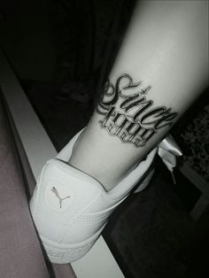 a black and white photo of someones leg with a tattoo that says stay strong on it