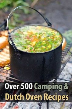 a pot filled with soup sitting on top of a grill next to hotdogs