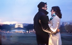 a man and woman standing next to each other in front of the lincoln memorial at dusk