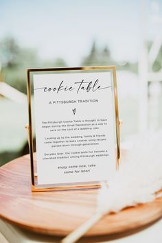 a table with a sign on it that says recipe table, and a white feather