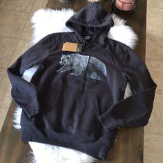 Unleash Your Wild Side With The Men’s Tnf Bear Pullover Hoodie. With Set-In Sleeves And A Comfortable Cotton-Blend Fabric, This Go-To Hoodie Is One You’ll Live In On Those Chilly (Or Just Chill) Days. 26” Long This Is Men’s But Could Fit A Women’s Size Medium Too Black Sweatshirt With Kangaroo Pocket For Outdoor Activities, Black Sweatshirt With Drawstring Hood For Outdoors, Black The North Face Hoodie For Streetwear, Black The North Face Sweatshirt For Fall, Casual Black The North Face Hoodie, Black Sweatshirt With Double-lined Hood For Outdoor Activities, Black Double-lined Hooded Sweatshirt For Outdoors, The North Face Fleece Crew Neck Sweatshirt, The North Face Hooded Sweatshirt For Streetwear