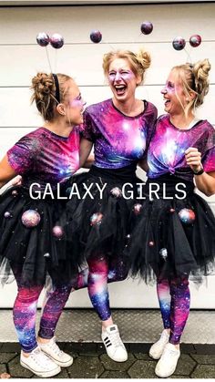 three girls in galaxy tutues laughing together