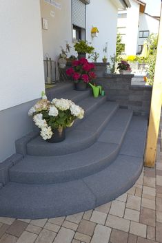 some flowers are sitting on the steps outside