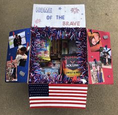 an open box with pictures and fireworks on the inside, in front of a flag