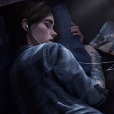 a person laying in bed with headphones on reading a book and listening to music