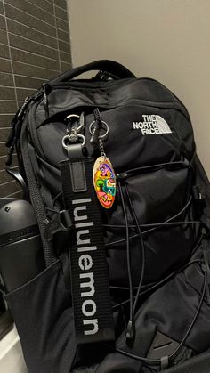 the north face borealis backpack, lululemon keychain, black owala water bottle Backpack College Aesthetic, Backpacks With Keychains, Black North Face Backpack Aesthetic, Lulu Backpack Aesthetic, Borealis Backpack Aesthetic, Black Jansport Backpacks Aesthetic, North Face Backpack Aesthetic, Owala Aesthetic, Black Backpack Aesthetic