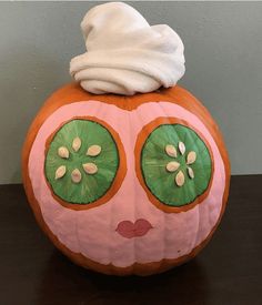 a pumpkin with eyes and a towel on top