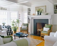 a living room filled with furniture and a fire place in front of a white fireplace