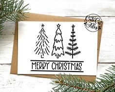 a card with christmas trees on it and the words merry christmas written in black ink