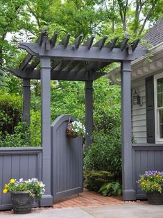 an image of a small garden with flowers on the fence and in front of it