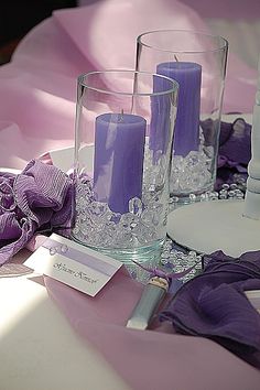 purple candles are sitting on the table