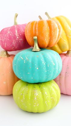 colorful painted pumpkins stacked on top of each other