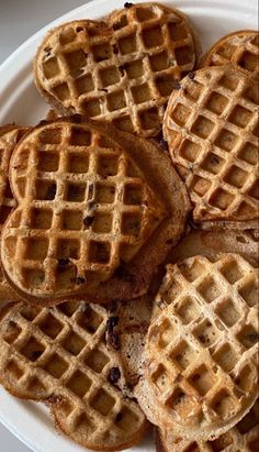 several waffles on a white plate sitting on a table