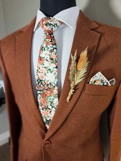 a suit with a flowered tie and matching pocket square