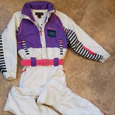 1990's Nevica Skiwear Vintage Zigzag Ladies One Piece Powder Ski Suit Thick Lined And Belted Long Sleeves Women's Size 8 Solid White With Pink & Purple Trim Fashion Styling Hood Inside Collar / 2 Front Zip Pockets In Pants And Top Jacket And Hidden Chest Pockets Wind And Water-Resistant Outerwear For Ski Heavier Winter Weight For All Season Wear 100% Polyester Easy Care Measures: Pit To Pit Flat ~ 22" Hips ~ Up To 36" Inseam ~ 31" (Regular Ladies ) Item Is Used And In Very Nice Condition ~ Showing No Rips / Looks Super! I Have Always Gotten Fabulous Compliments On This Suit When Wearing. Palm Springs Lady Sporting Goods Specialist Since 1992 Ships Promptly When Paid Trims Fashion, Pants And Top, Purple Trim, Ski Suit, Hip Ups, Ski Suits, Snow Skiing, Fashion Styling, Snow Suit