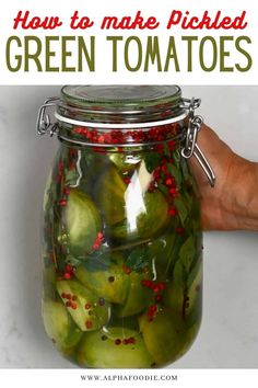 pickled green tomatoes in a jar with text overlay